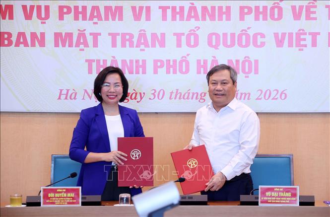 Chủ tịch UBND thành phố Hà Nội Vũ Đại Thắng và Chủ tịch Uỷ ban MTTQ Việt Nam thành phố Hà Nội Bùi Huyền Mai ký kết Biên bản bàn giao tại hội nghị. Ảnh: Văn Điệp - TTXVN