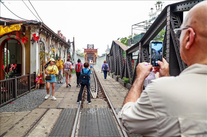 Dù đang trong quá trình sửa chữa, cầu Long Biên vẫn là điểm dừng chân thu hút du khách tìm đến tham quan. Ảnh: Vân Chi/TTXVN phát