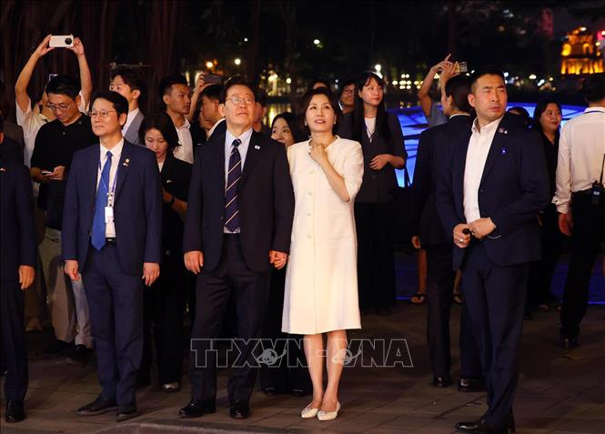 Tổng thống Hàn Quốc Lee Jae Myung và Phu nhân Kim Hae Kyung có những phút giây thư giãn đi dạo bên hồ Hoàn Kiếm. Ảnh: Phạm Kiên - TTXVN