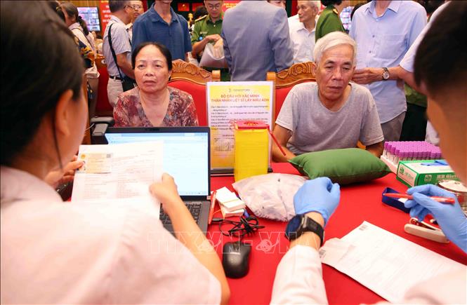 Thân nhân Liệt sĩ chưa xác định thông tin trên toàn quốc làm thủ tục lấy mẫu sinh phẩm ADN tại buổi lễ. Ảnh: Phạm Kiên - TTXVN